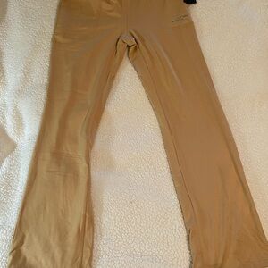 Bebe Tan Casual Pants Straight Leg Size Large. Has stains on hem.  NWT